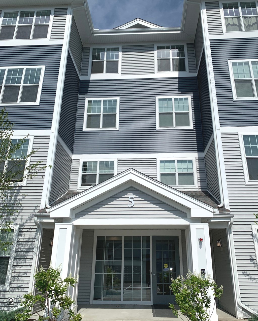 the front entrance of a condo building with the door open