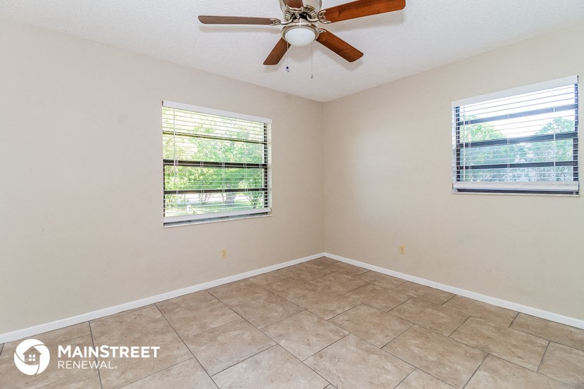 the living room of a home with a ceiling fan