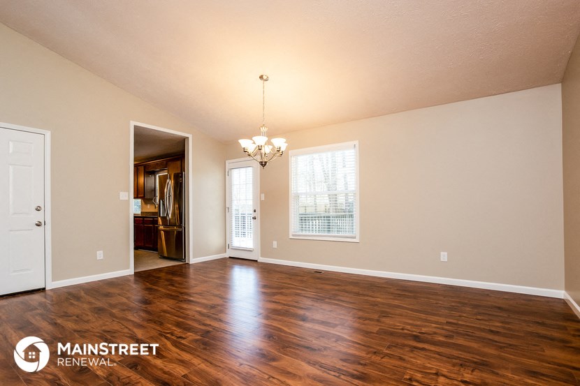 the living room and dining room with hardwood flooring