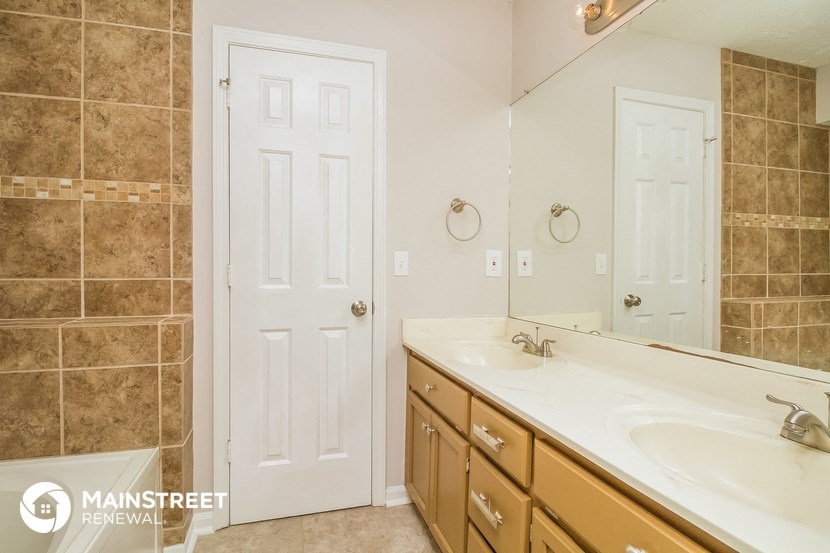 a bathroom with two sinks and a large mirror