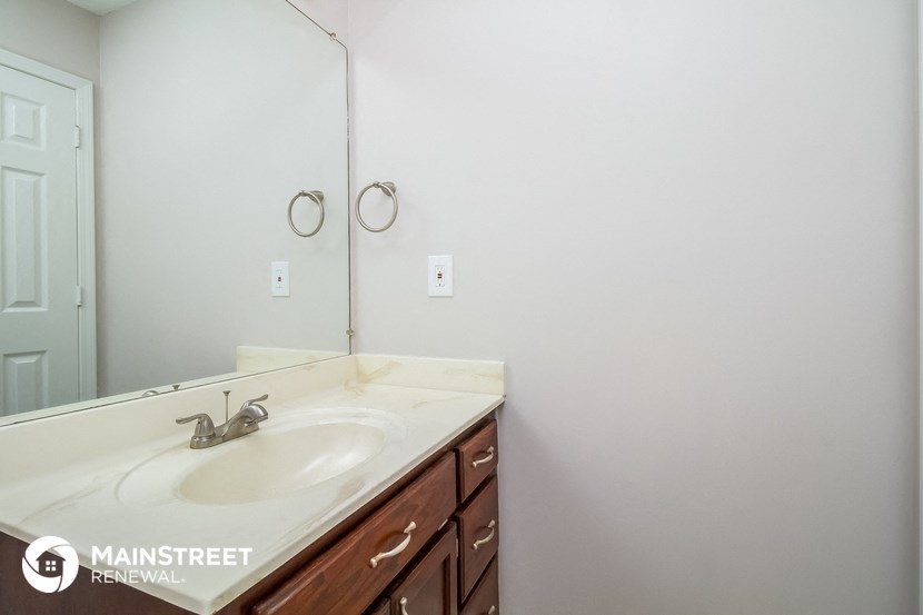 a white bathroom with a sink and a mirror