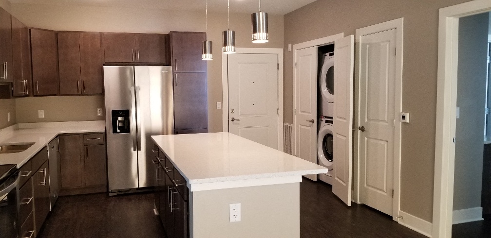 a kitchen with stainless steel appliances and a white counter top