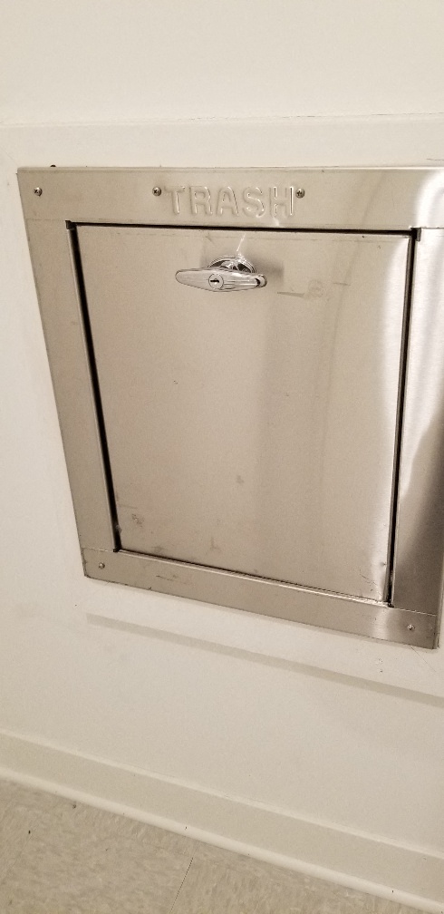 a stainless steel safe in a white wall