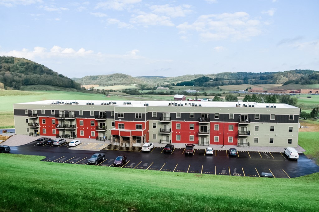 an aerial view of an apartment building in a parking lot
