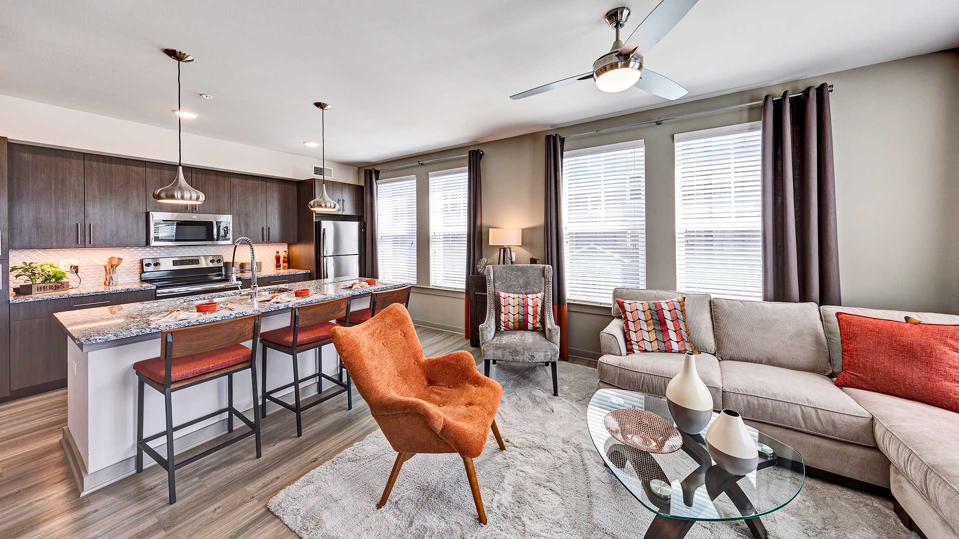 a living room with a kitchen and a couch
