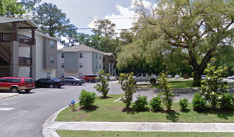 a city street with houses and trees and a fire hydrant