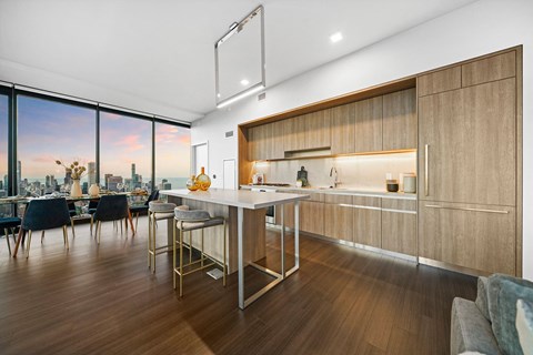 A modern kitchen with a dining table and chairs.