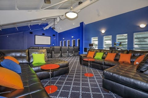 a living room with blue walls and leather couches