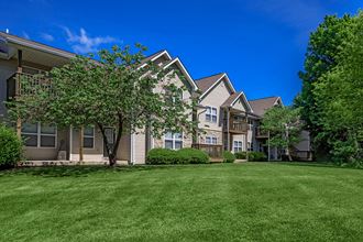 a row of houses with grass and trees