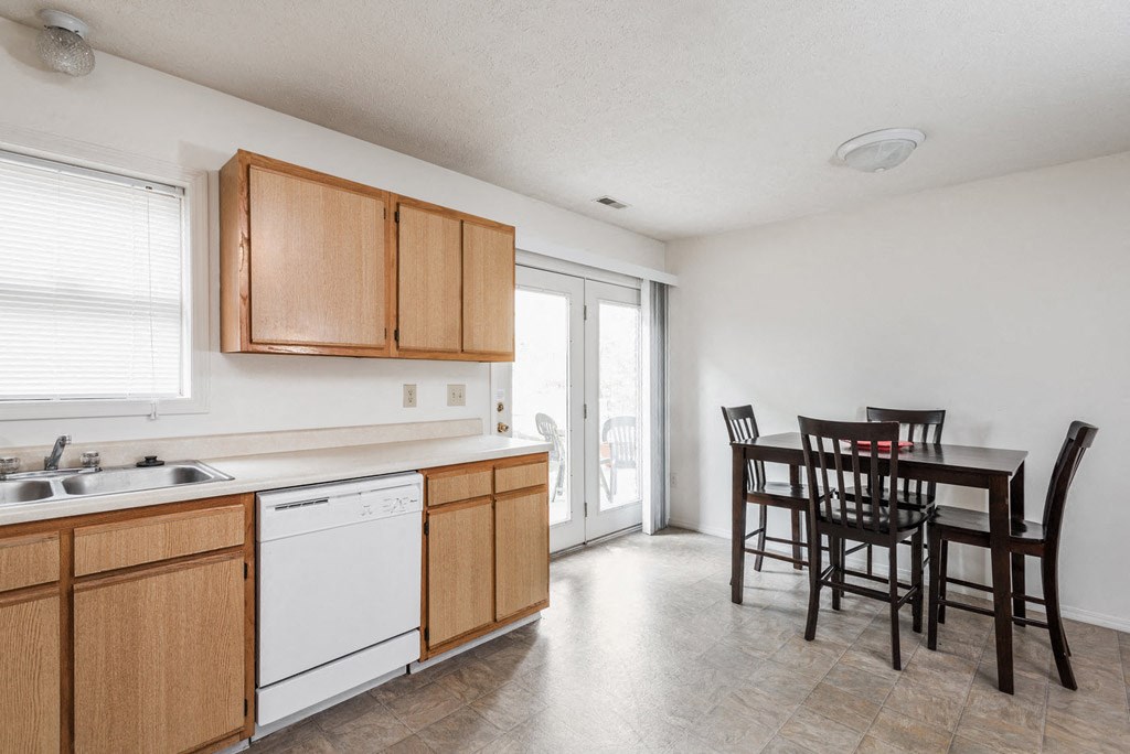a kitchen and dining room with a table and chairs