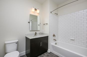 Elegant bathrooms with dark wood vanities, white subway tiles, and brushed nickel fixtures