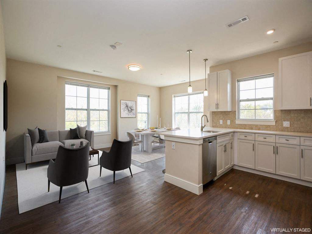 a kitchen and living room with a table and chairs