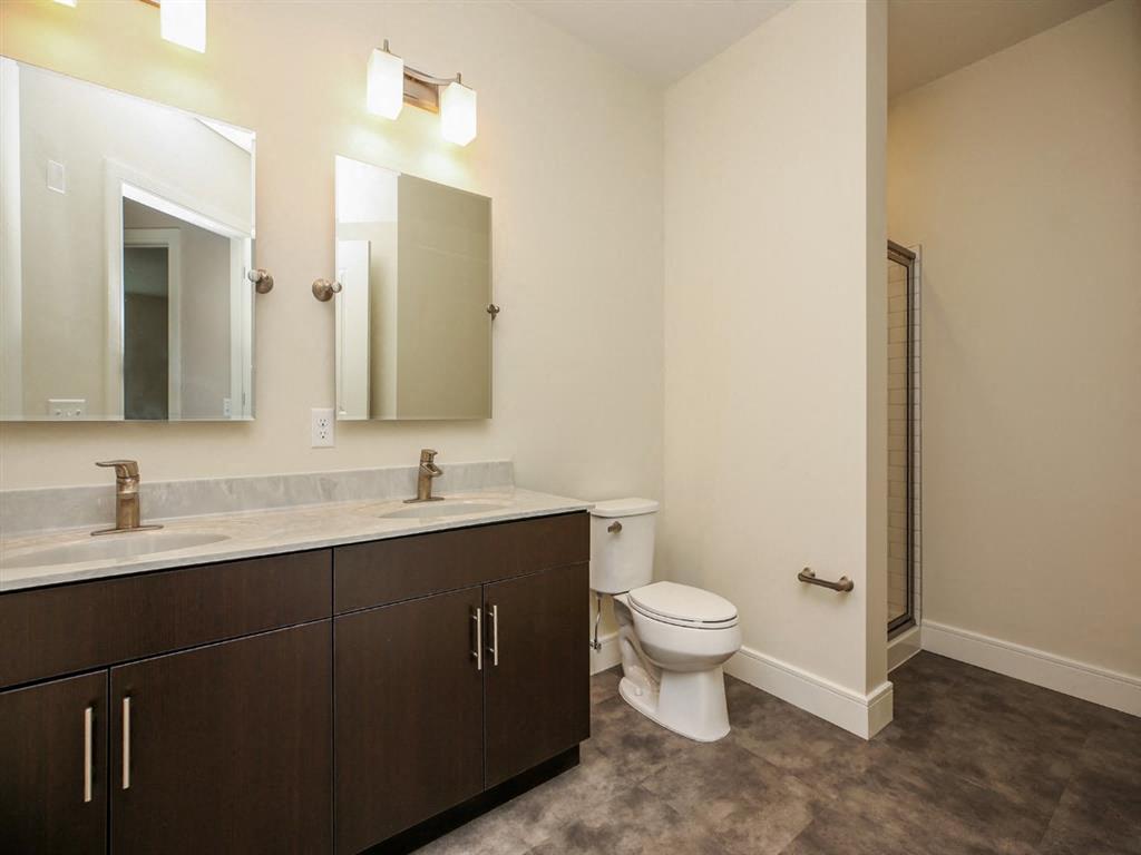 a bathroom with a toilet and a sink and a mirror