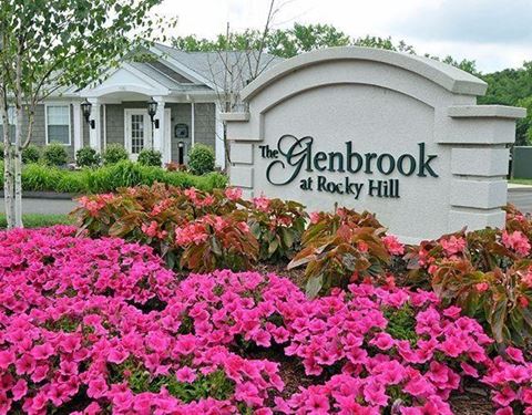 a sign for the gedbrock at rock hill with pink flowers