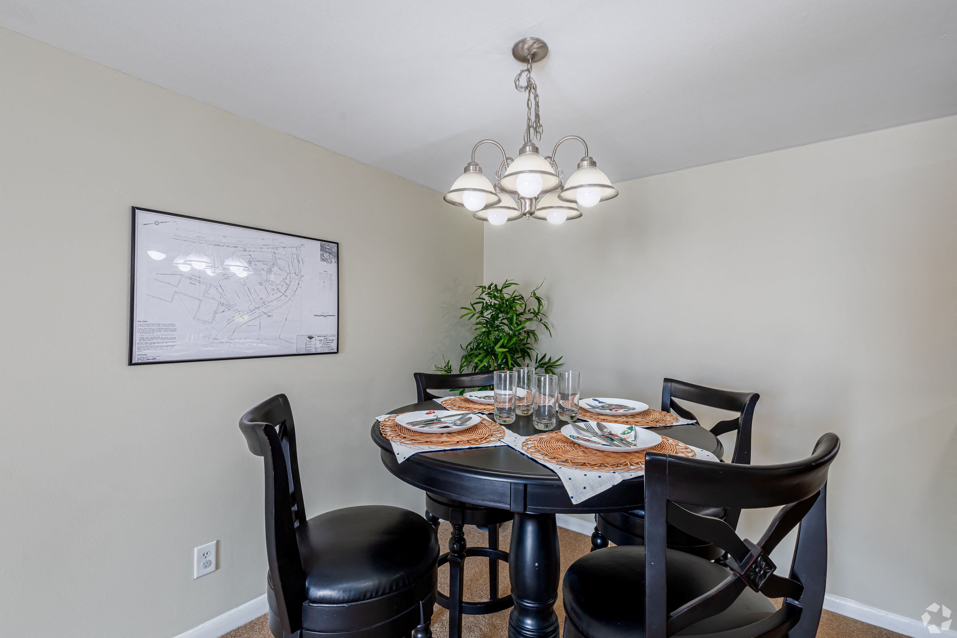 a dining room with a table and chairs and a chandelier