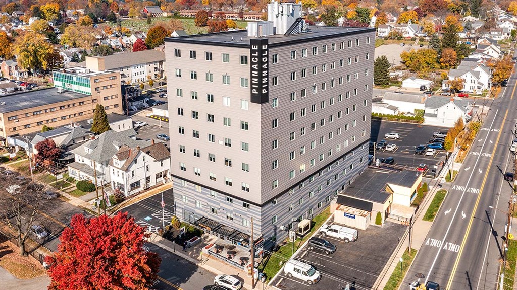 an aerial view of a tall building in a city