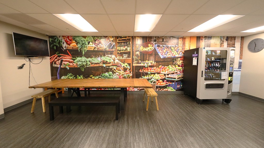 a dining room with a table and a vending machine