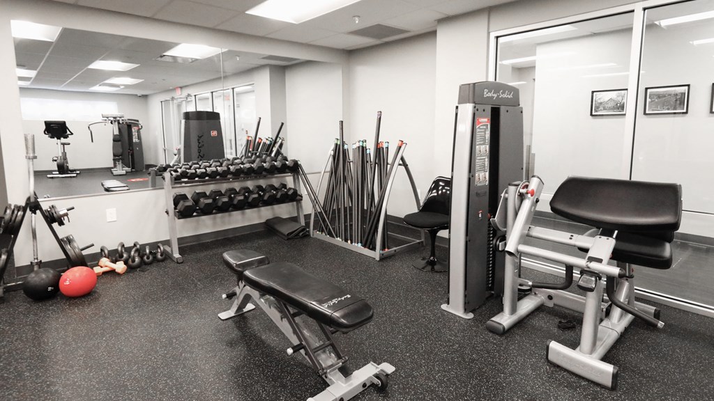 a gym with weights and other exercise equipment in a building