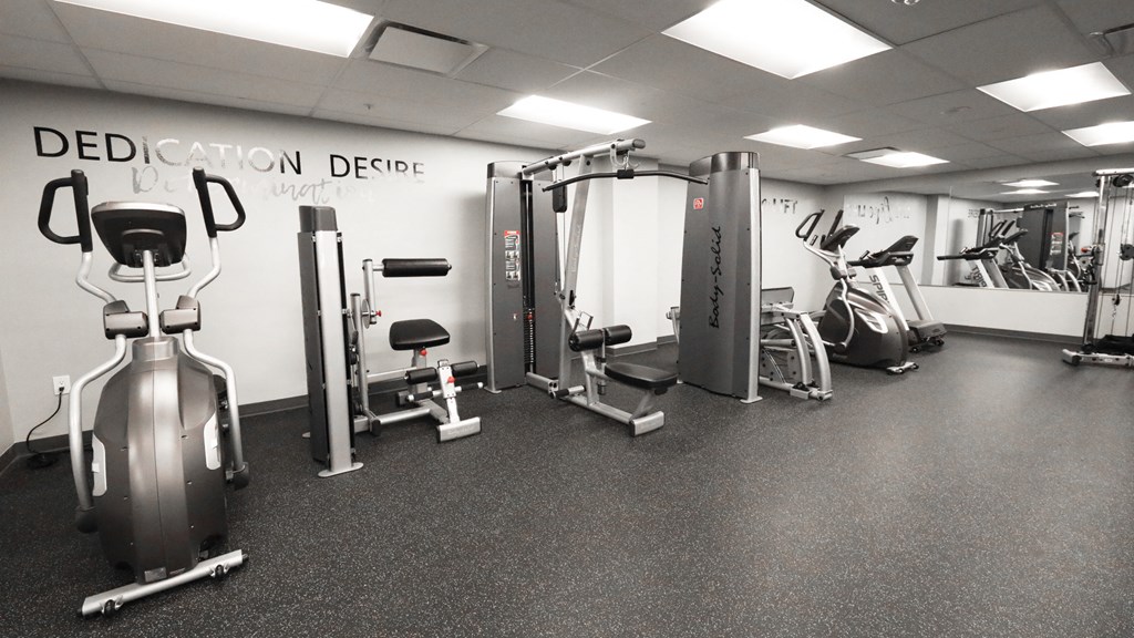 a gym with cardio equipment and weights in a treatment room