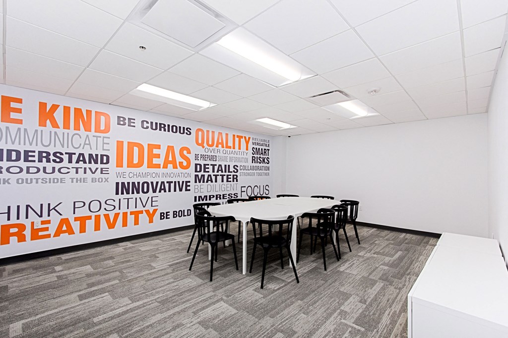 a conference room with a large wall mural in the corner