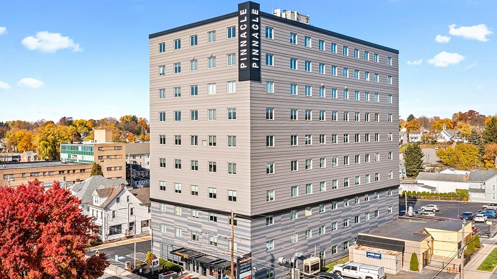 an aerial view of a tall building in a city
