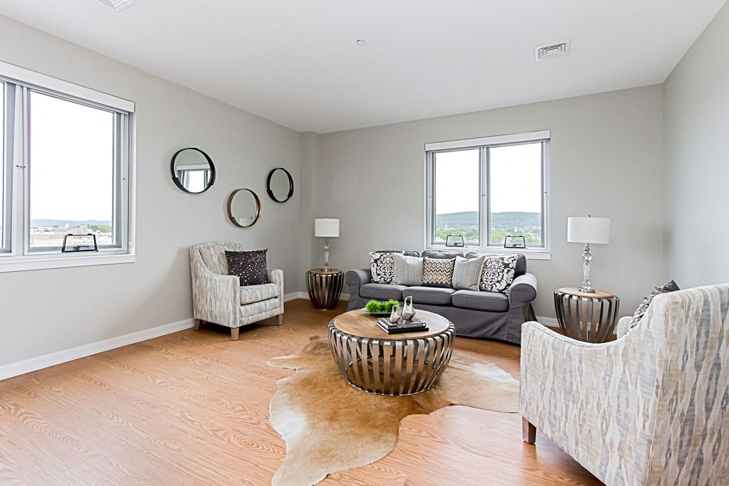 a living room with couches and chairs and a table