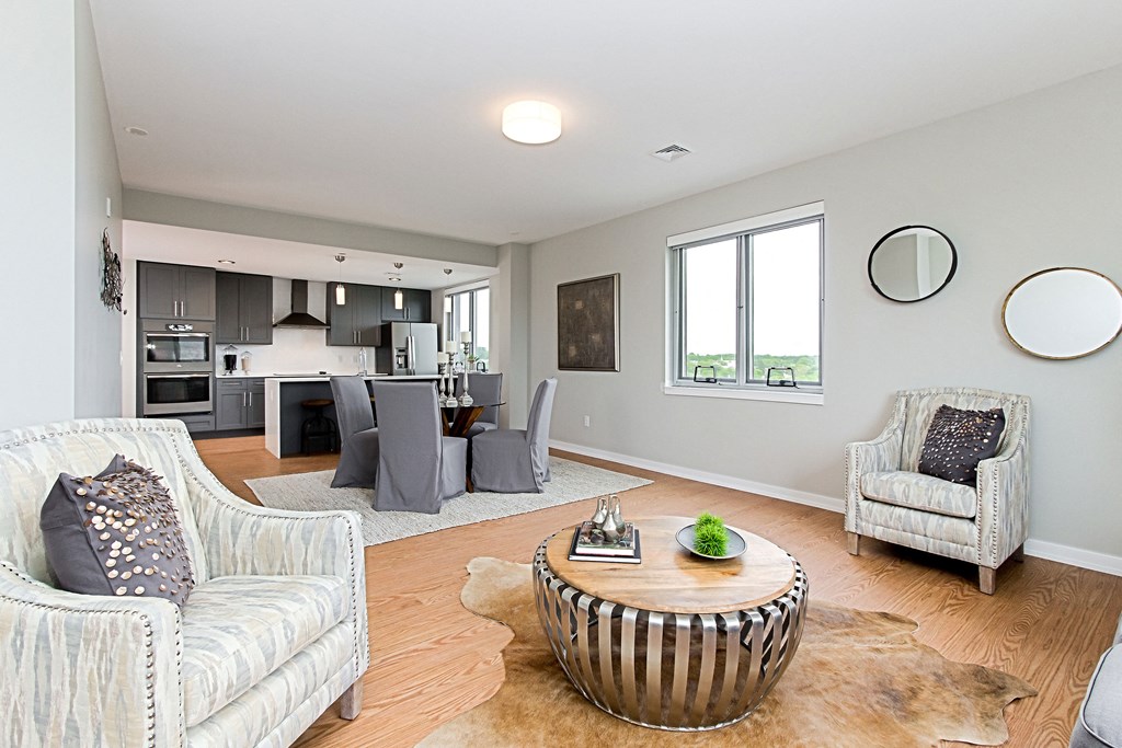 a living room with couches and chairs and a table