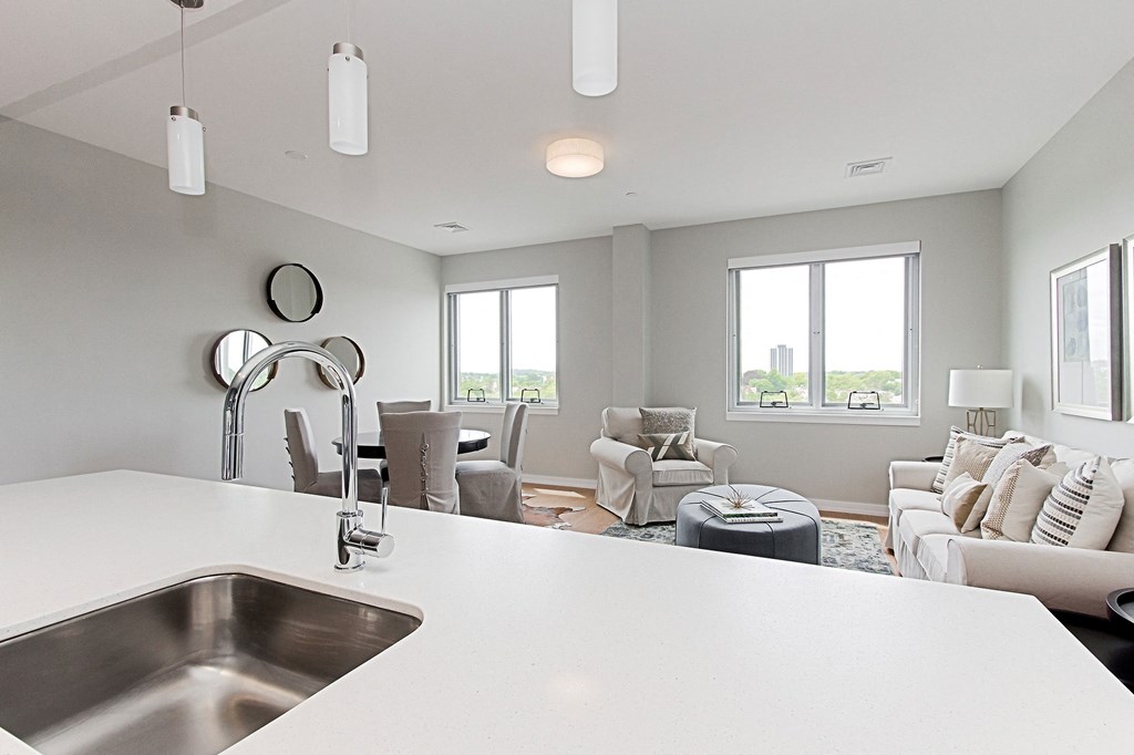 a kitchen with a sink and a view of a living room