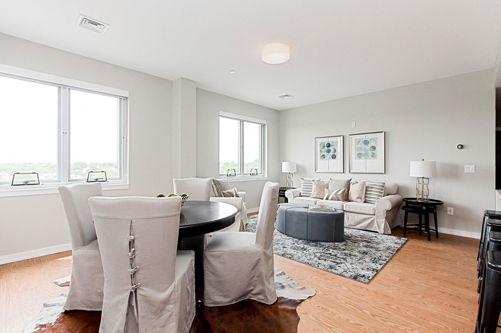 a living room with couches and chairs and a table