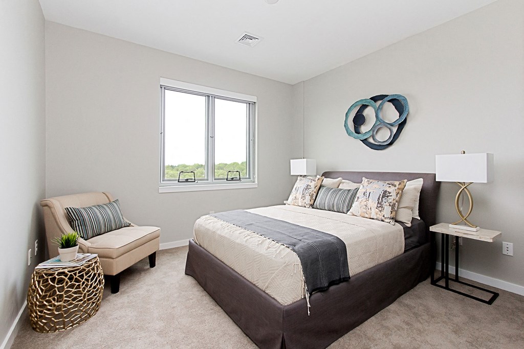 a bedroom with a bed and a window