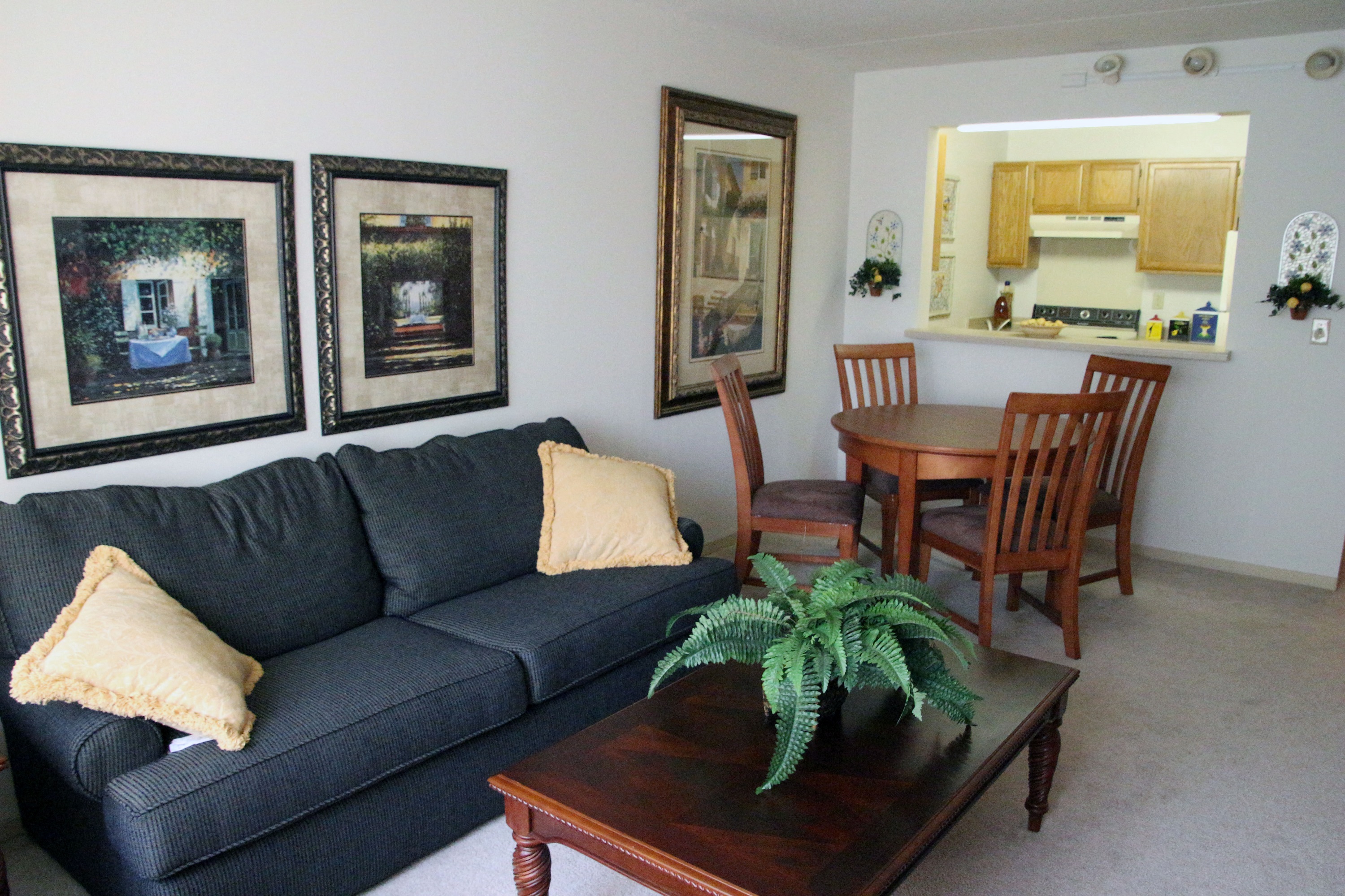a living room with a couch and a dining room table