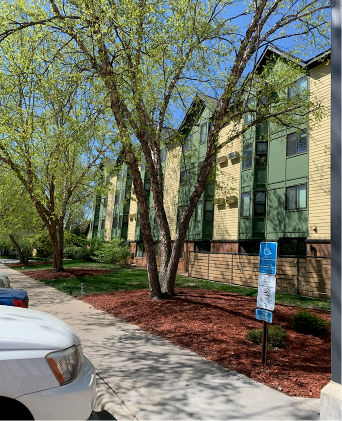 a car parked in front of an apartment building