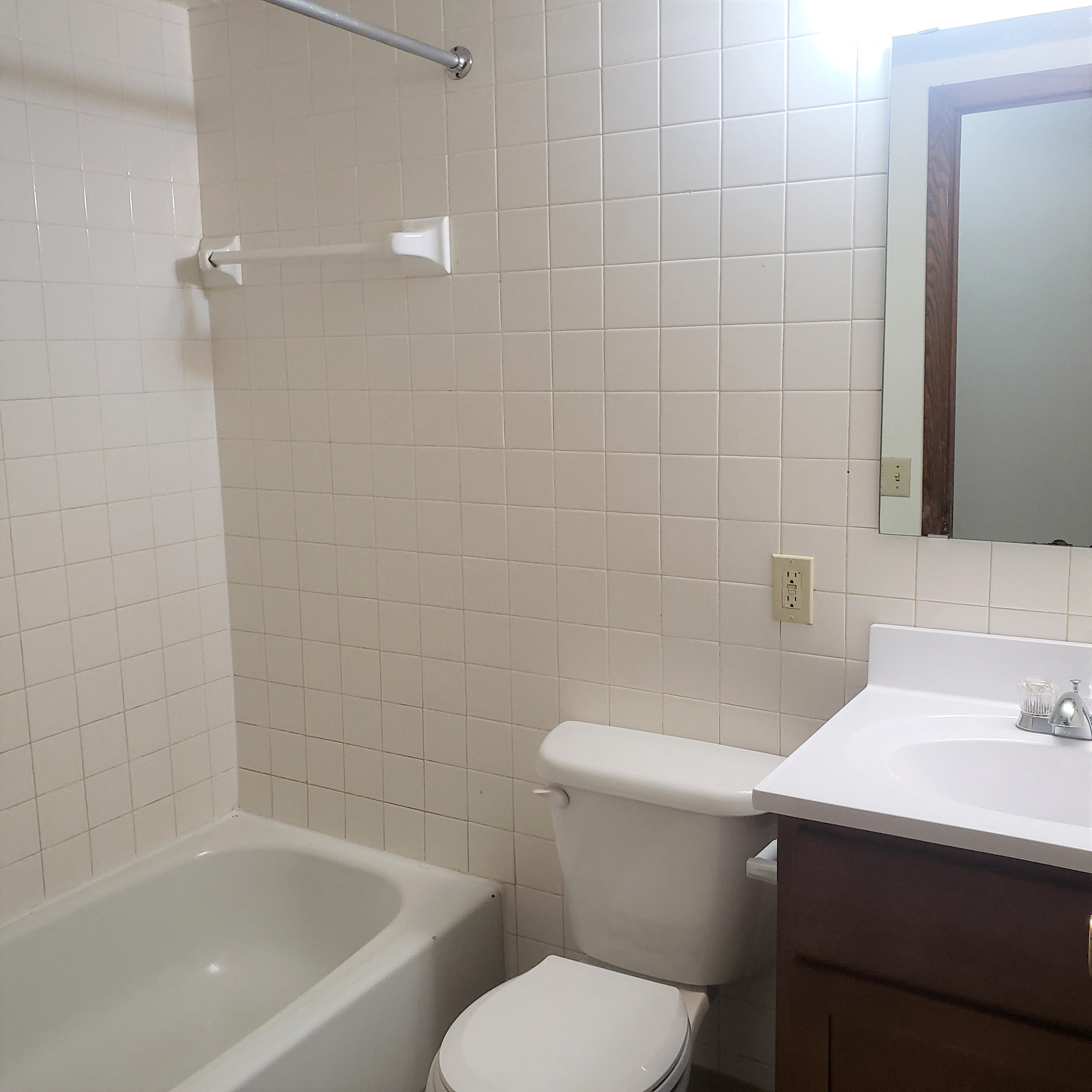 a bathroom with a toilet and a sink and a bath tub