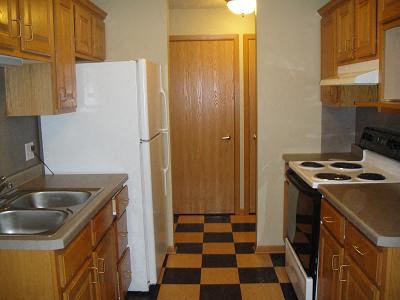 a kitchen with a stove and a refrigerator