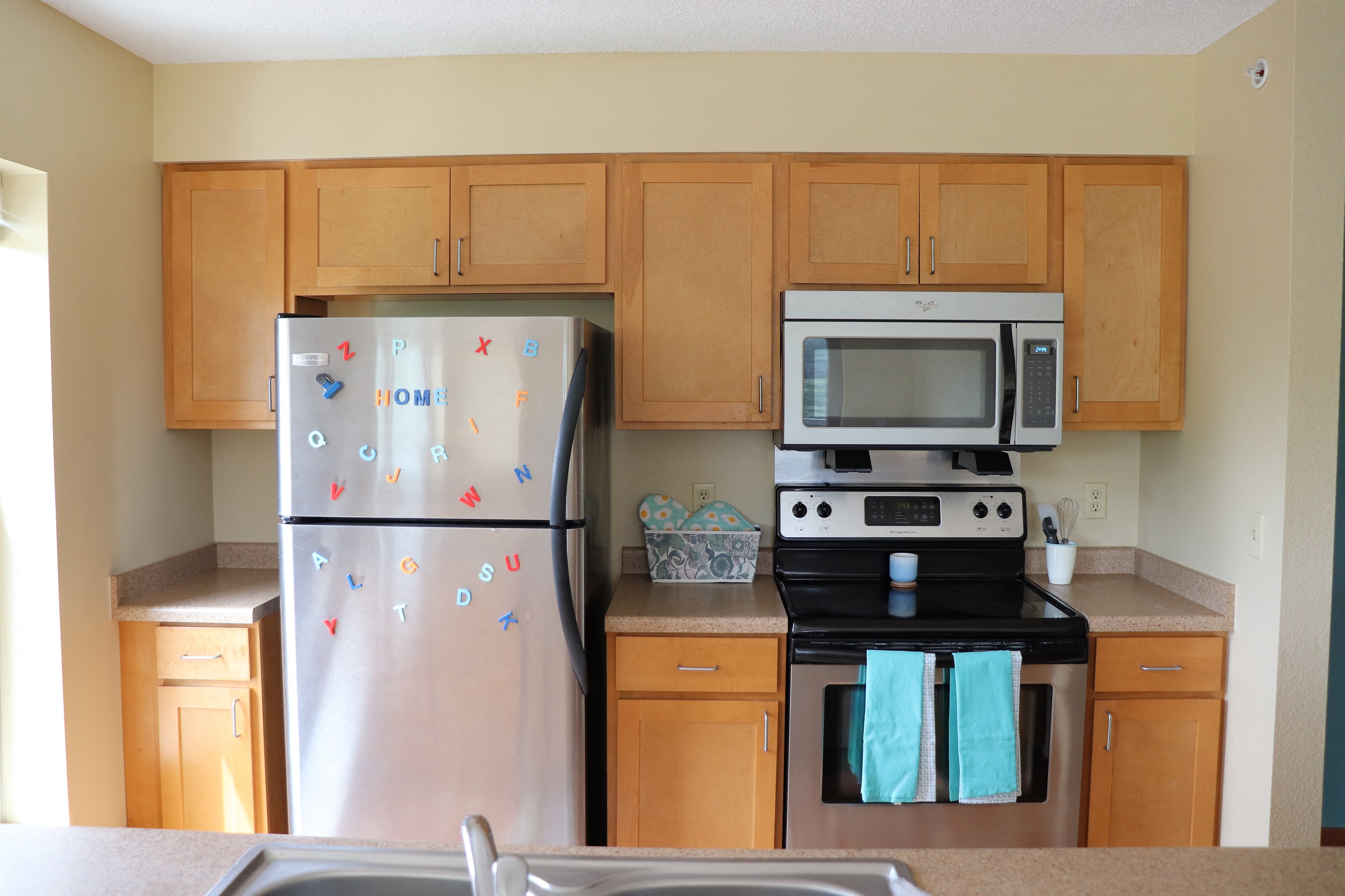 a kitchen with stainless steel appliances and wooden cabinets