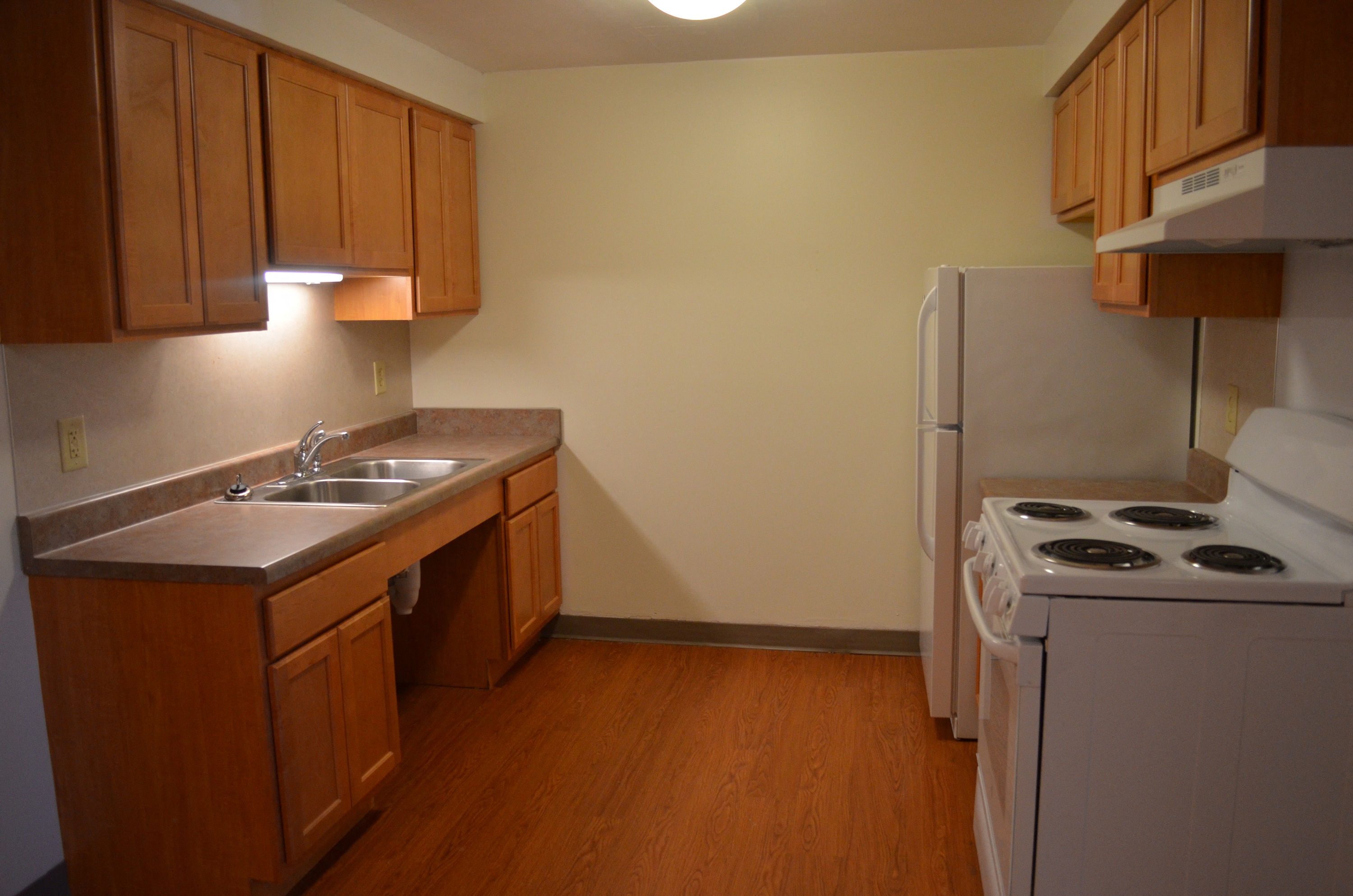 a kitchen with a stove sink and refrigerator