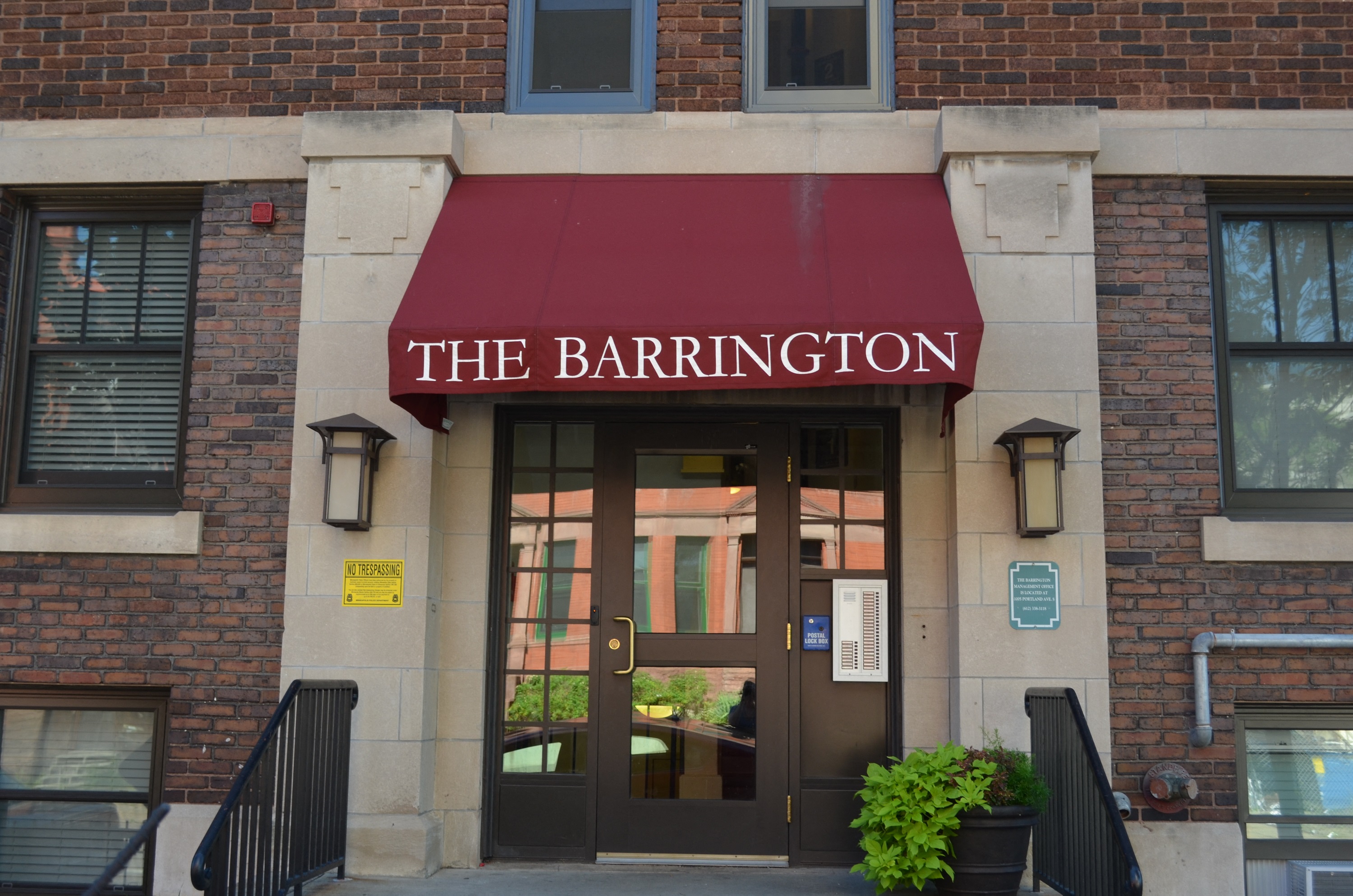 the front of the barrington building with a red awning