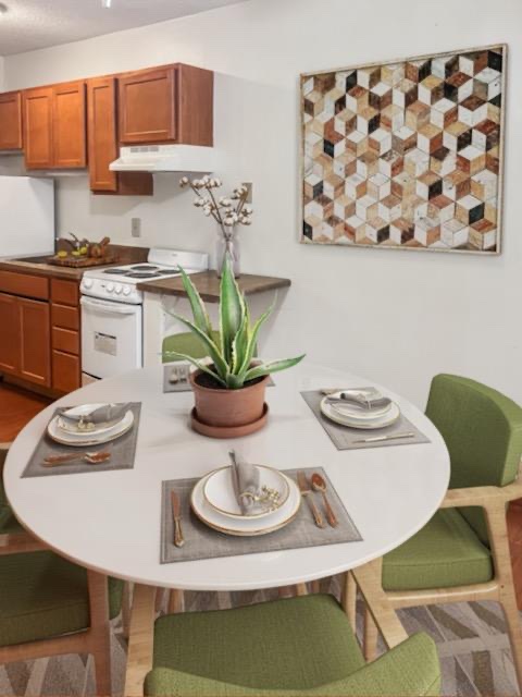 a kitchen and dining room with a table and chairs