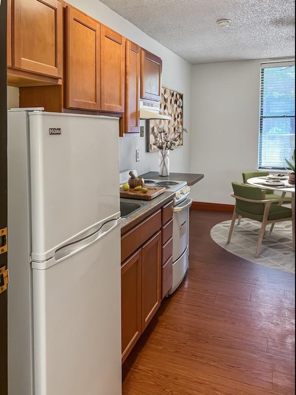 a kitchen with a refrigerator and a table