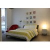 A bed with a yellow and white striped comforter.