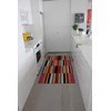 A hallway with a striped rug on the floor.