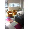 A yellow chair is in front of a desk with a computer.