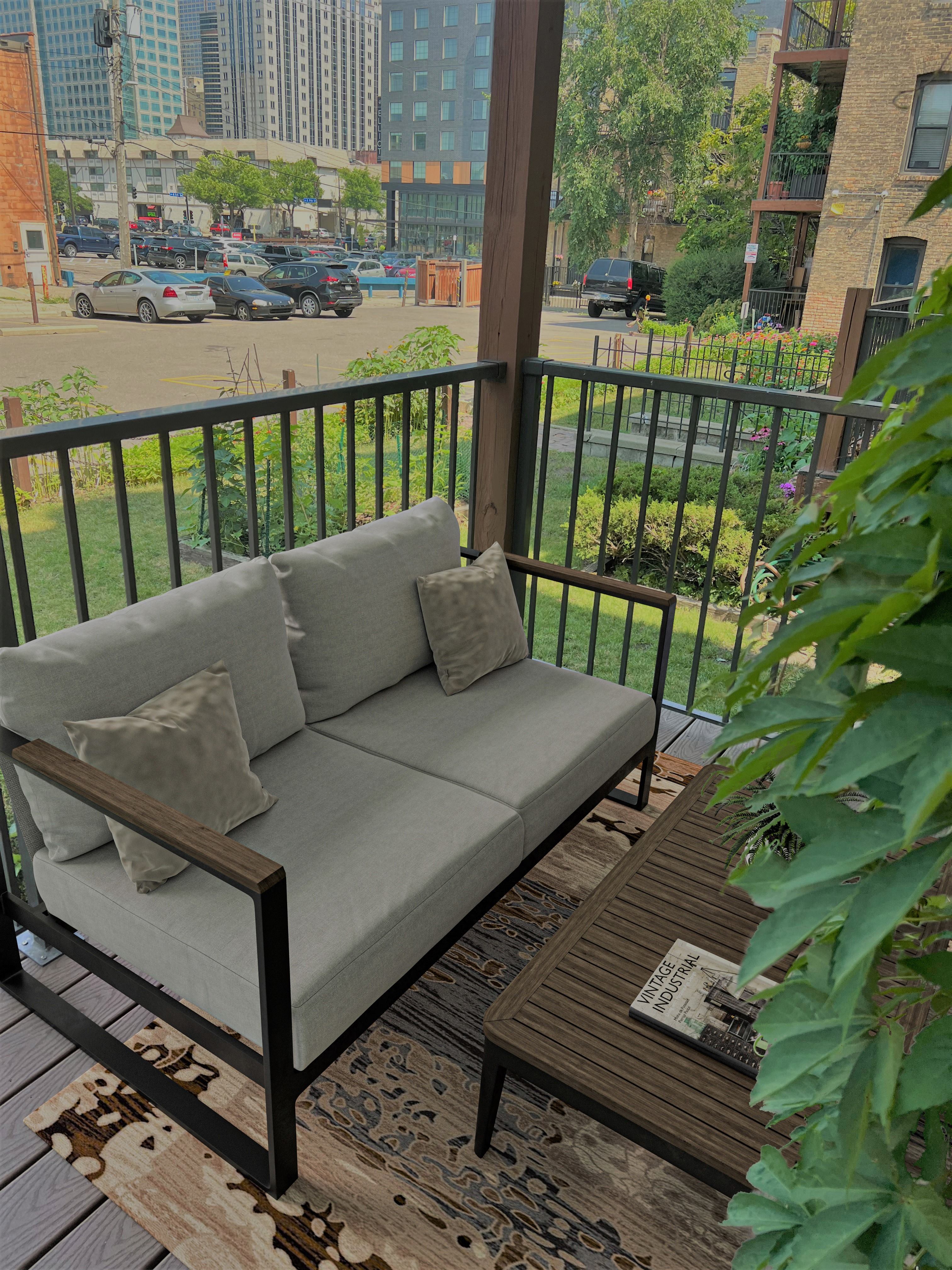 a couch on a balcony with a city in the background
