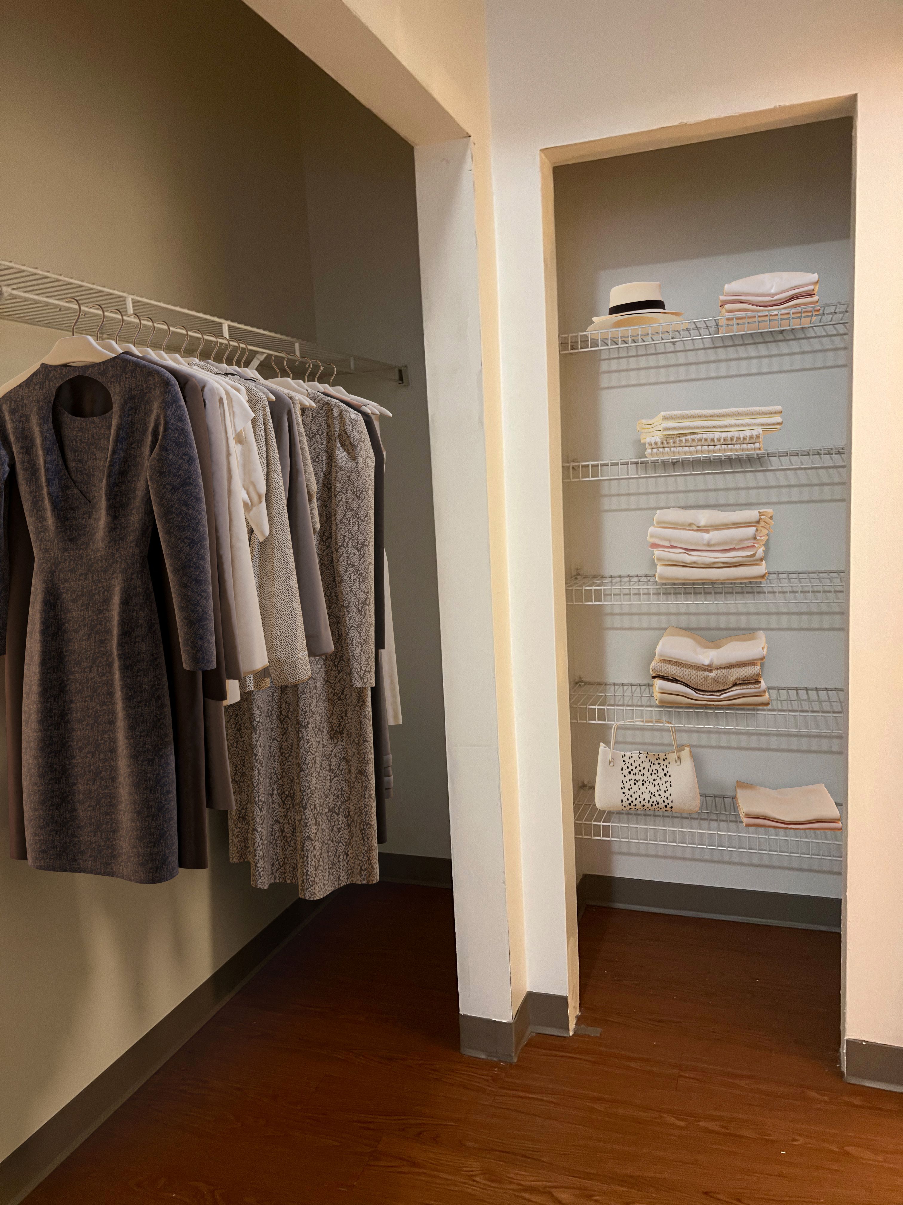 a walk in closet with a rack of clothes and a closet door open