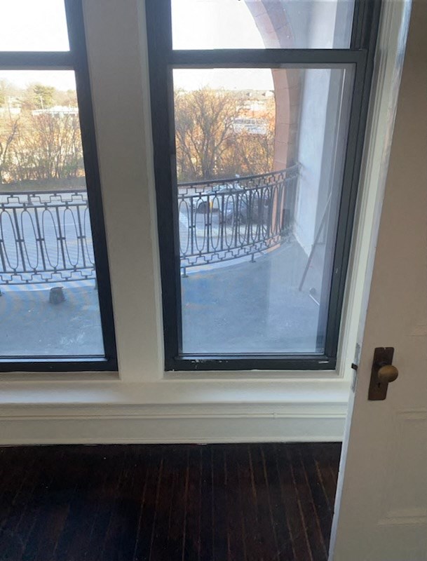 a window with a view of a balcony in a room