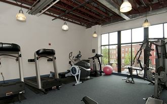 a gym with exercise equipment and a window