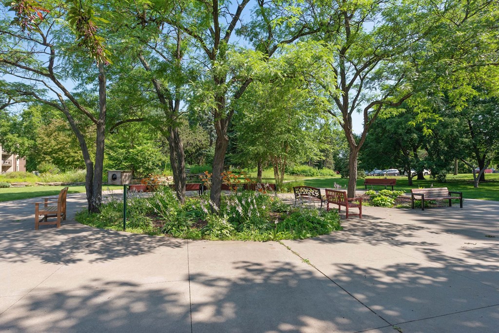 A park with benches and trees at Humboldt Senior 55+ Apartments, Saint Paul, MN