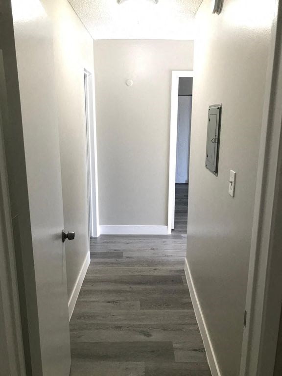 a hallway with white walls and a door