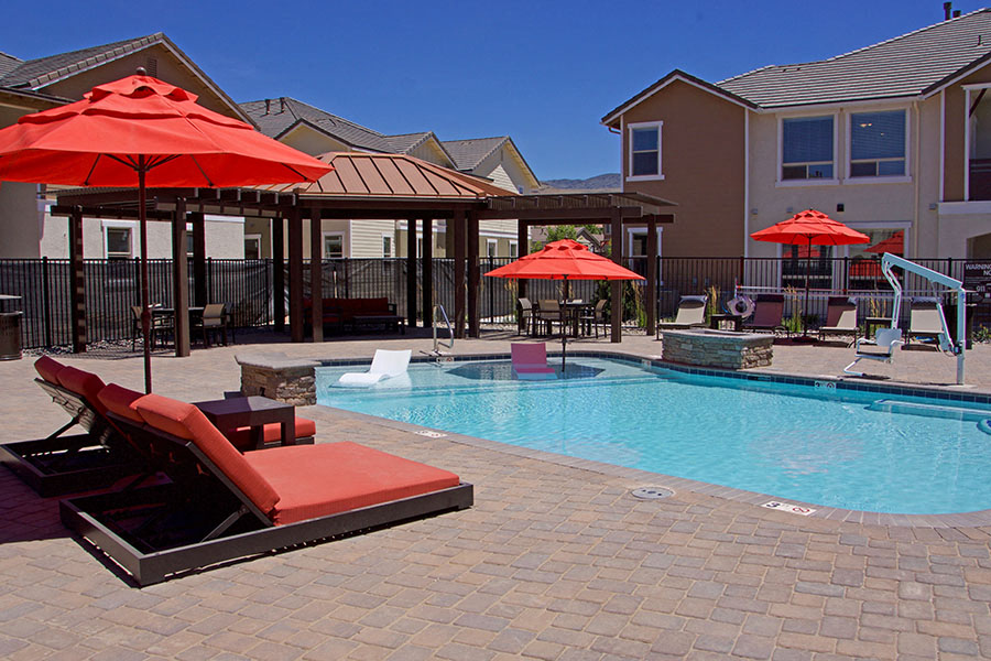 Pool with lounge chairs  l Silverado Apartments in Sparks NV