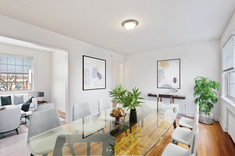 a dining room with a glass table and chairs